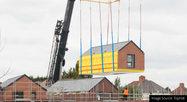 Photograph of a housing unit using modern methods of construction being craned into place
